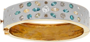 White and irradiated colored diamond bangle in 14k white and yellow gold.