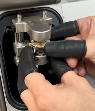 Watch being placed into a pressure-testing chamber