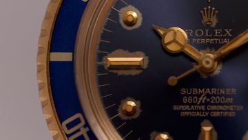Aged luminous hour markers and hands on a vintage watch dial