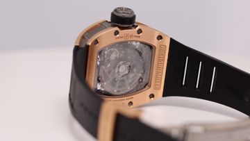Condensation visible beneath the rear crystal of a rose-gold luxury watch