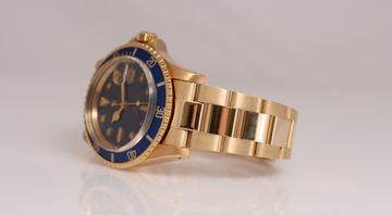 Vintage gold Rolex Submariner with visible age and patina