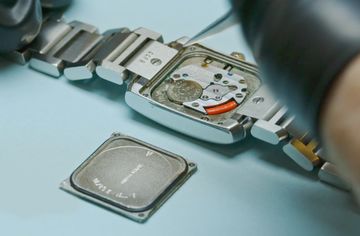 Opened rectangular quartz watch with its battery visible