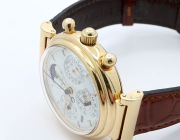 Gold high-complication watch with crown and pushers in close view