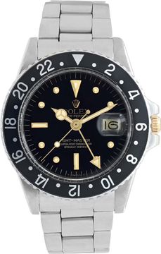 Vintage Rolex GMT-Master with black 24-hour bezel, red GMT hand, and date magnifier