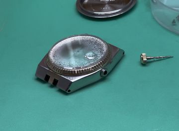 Vintage watch with heavy condensation beneath the crystal and a detached crown