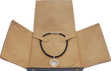 Bvlgari mother of pearl and onyx pendant in 18k and stainless steel on a black cord necklace.