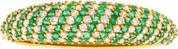 Diamond and emerald bangle in 18k yellow gold.