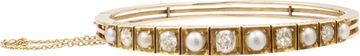 Diamond and natural pearl bangle in 14k gold