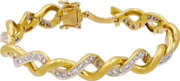 Elegant twisted bracelet in 18k yellow and white gold featuring over 2.50 in diamonds Bracelet Collection