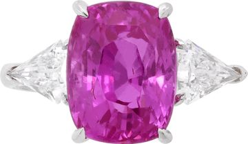 GIA Certified pink sapphire and diamond ring in platinum. 7.04 carat cushion cut pink sapphire (heated) and 0.96 carats in side kite cut diamonds (E-F color, VS1 clarity).