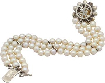 Pearl bracelet with 14k white gold clasp with with pearl andemerald accents