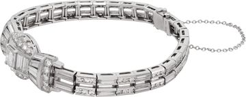 Platinum bracelet set with round, emerald, tapered baguette, and baguette-cut diamonds totaling approximately 5.00 carats