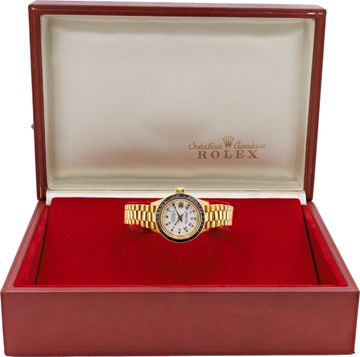 Ladies Rolex Datjust in 18k yellow gold with custom blue sapphire bezel