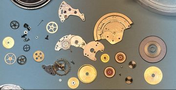 Disassembled Rolex Submariner 1680 movement components laid out during professional service