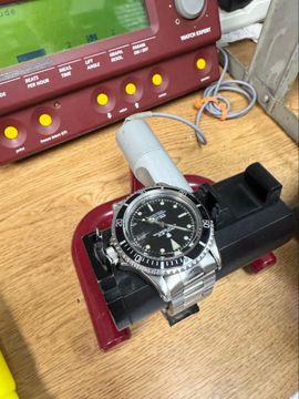 Vintage Rolex Submariner 1680 on timing machine during accuracy regulation