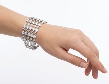 Wide multi-row diamond bracelet in 18k white gold with articulating circular links. Over 37 carats in round diamonds